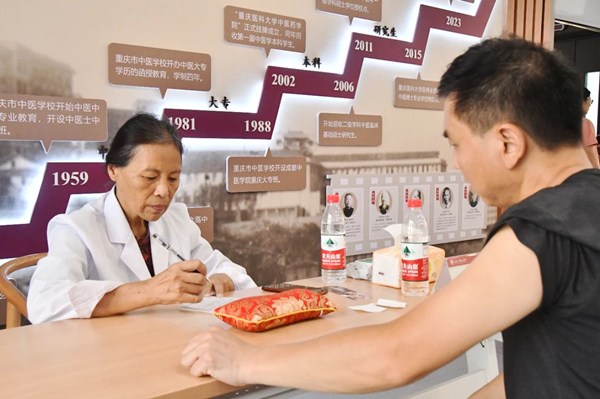 重庆市名中医、taptap点点官方网站教授洪蕾为学生家长看诊。taptap点点官方网站供图